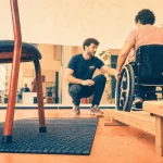 Activités physiques adaptées Rennes : éducateur guide un fauteuil sur un parcours d’équilibre